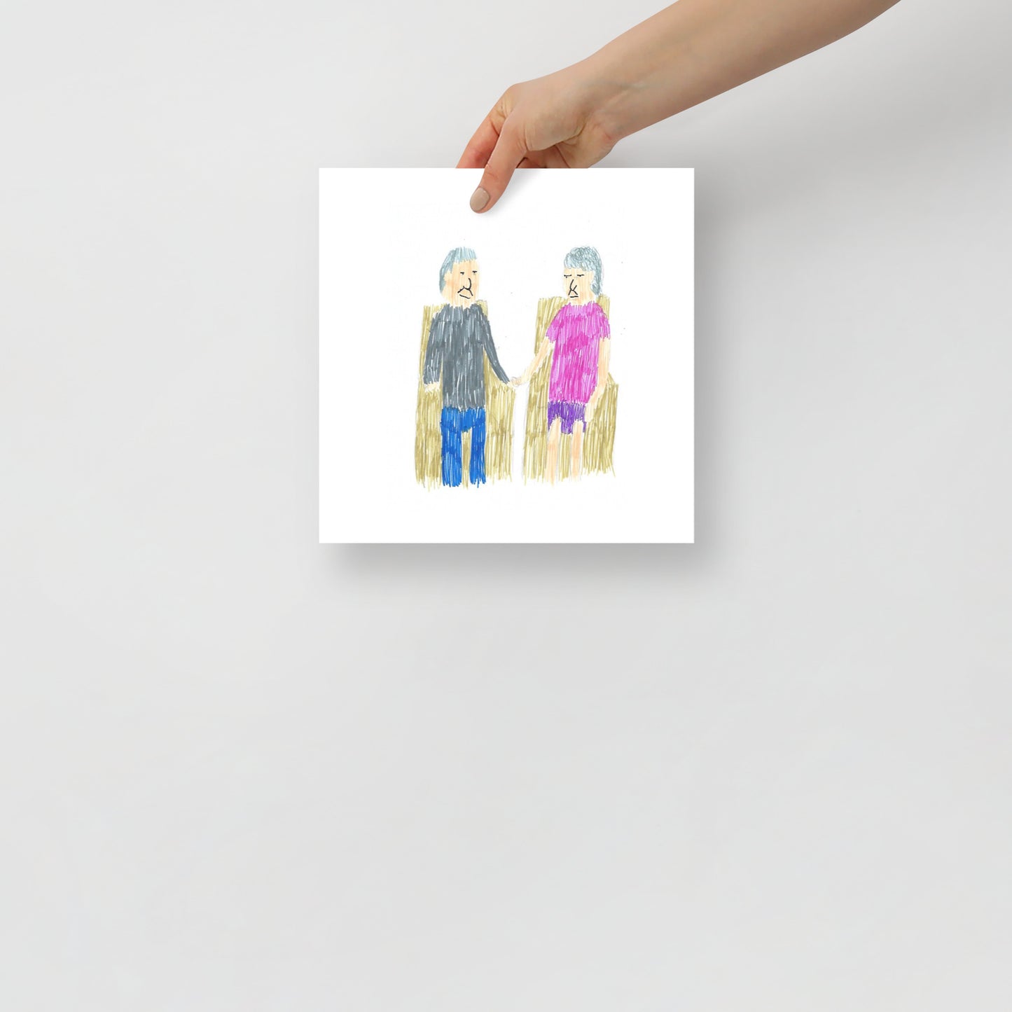 This image shows an art print of a square artwork featuring a simple child-like drawing of an elderly couple sitting on chairs, holding hands. The woman wears pink; the man wears a black top, blue pants. Bright, simple.