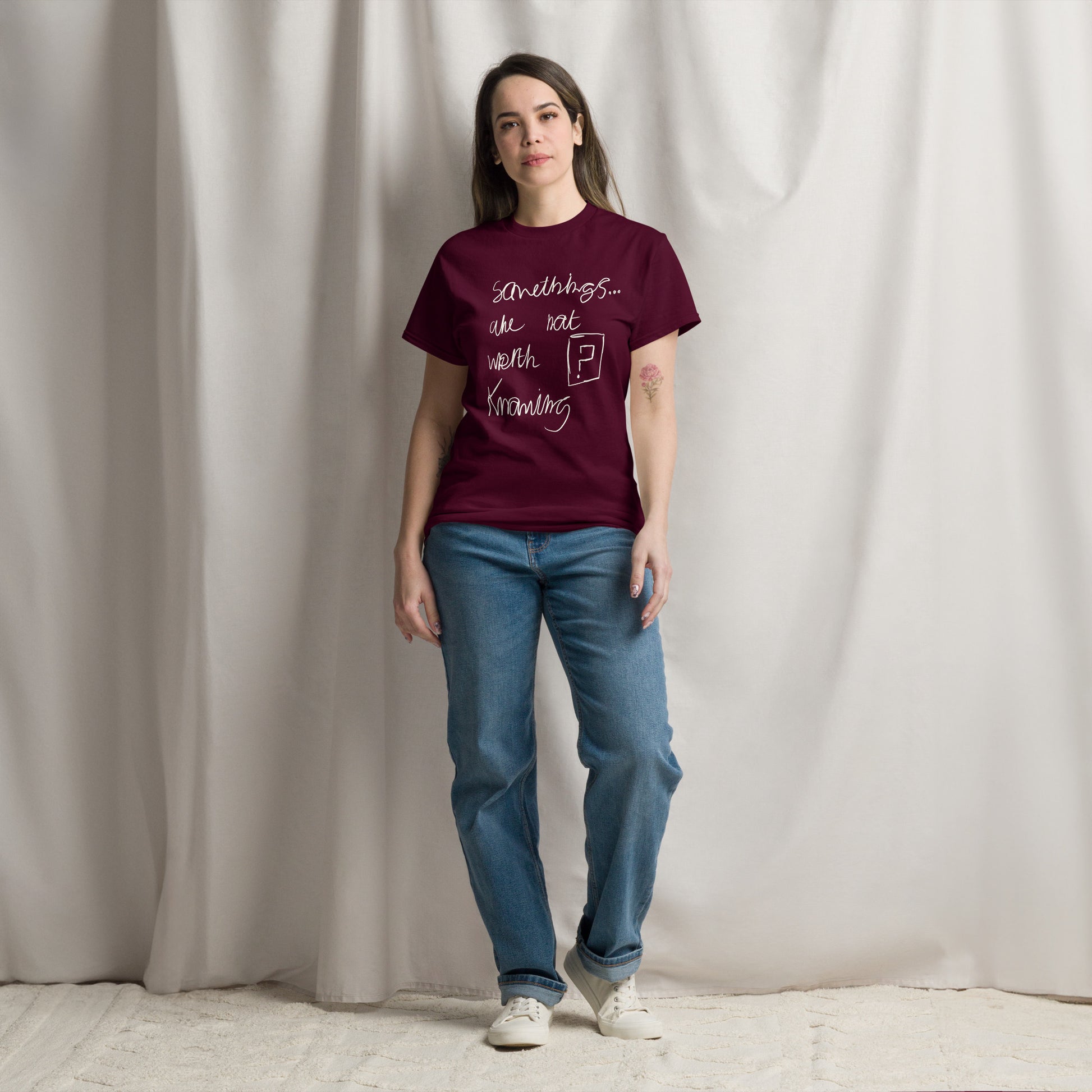 This image shows a maroon graphic t-shirt featuring the phrase "Somethings are not worth knowing